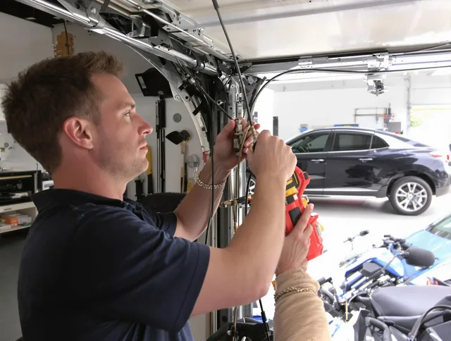 New Canaan Garage Door Repair safety certified technician performing cable replacement in New Canaan